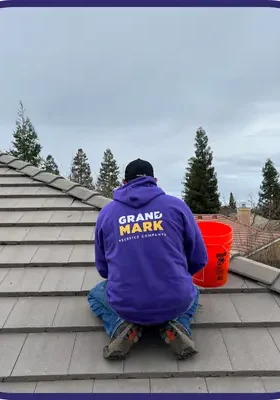 Roofing repair team on damaged roof