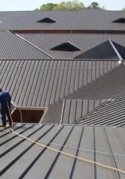 Commercial Metal Roofing roof inspection crew with safety gear on site